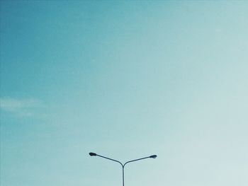 Low angle view of street light against clear blue sky