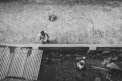 High angle view of men standing on footpath