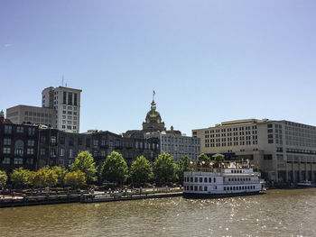 Buildings in city against clear sky