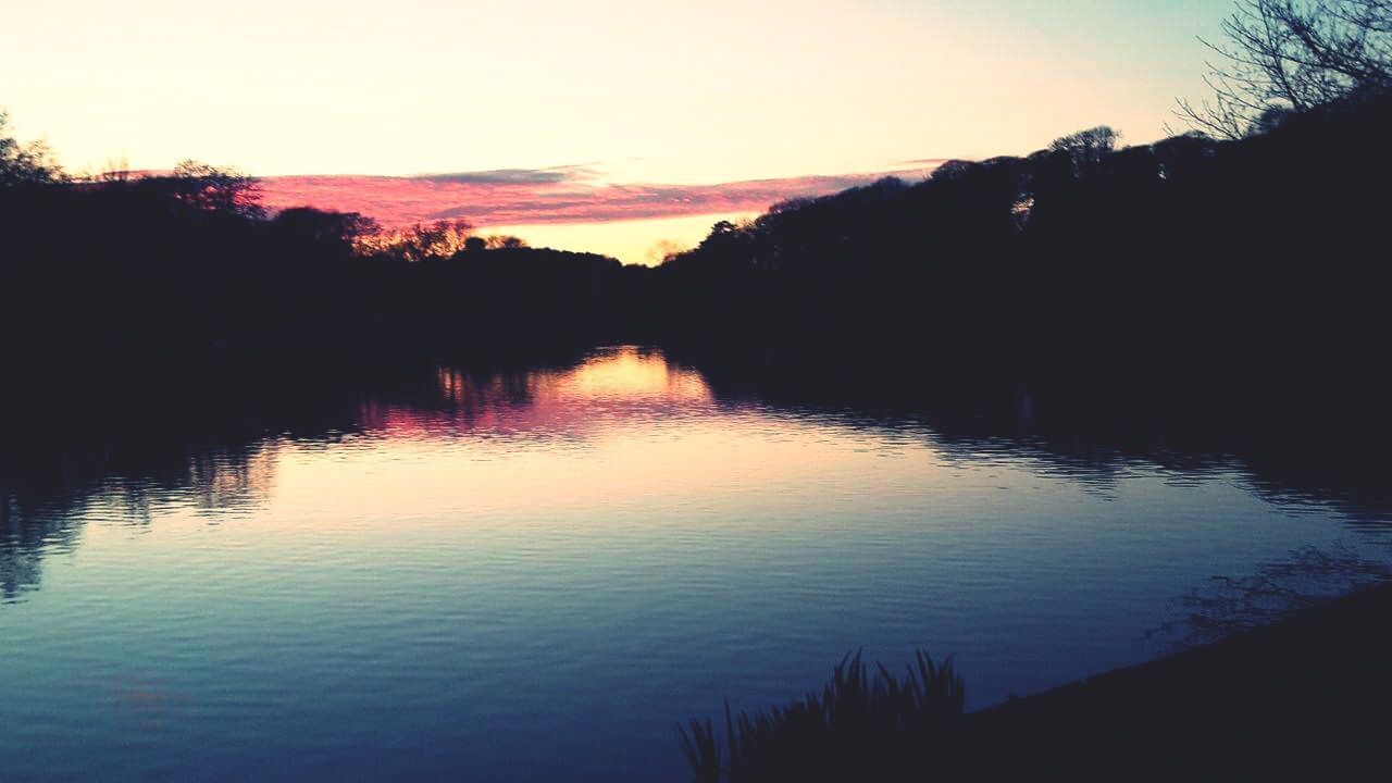 SUNSET OVER CALM LAKE