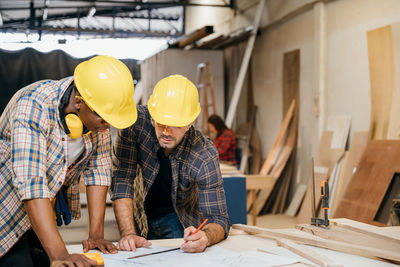 Rear view of man working at workshop