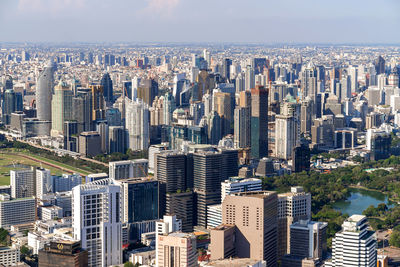 Aerial view of buildings in city against sky