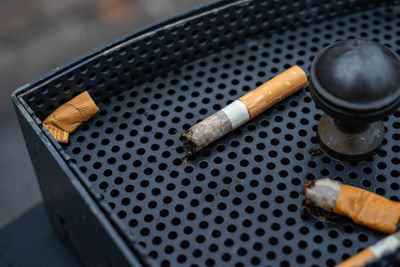 High angle view of cigarette butts on ashtray