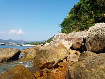 Rock formations by sea against sky