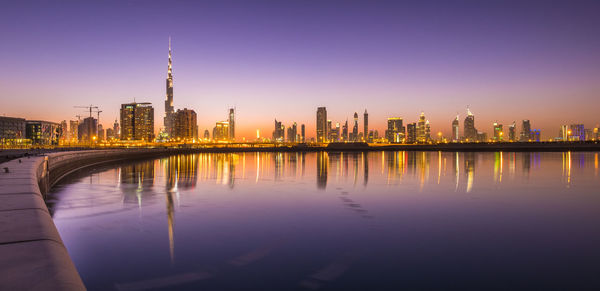 Reflection of illuminated buildings in city at night