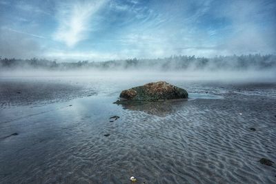 Scenic view of sea against cloudy sky