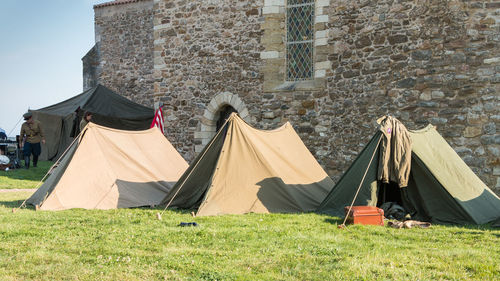 Tent on field against buildings