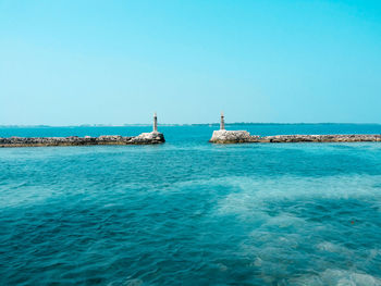 Scenic view of sea against clear blue sky