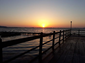 Scenic view of sea against clear sky during sunset