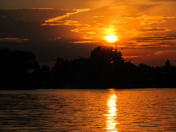 Scenic view of lake against romantic sky at sunset