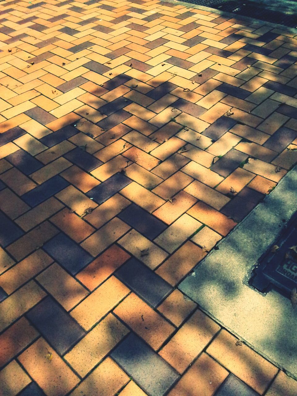 full frame, pattern, backgrounds, high angle view, textured, paving stone, cobblestone, tiled floor, sunlight, repetition, shadow, no people, outdoors, flooring, day, design, footpath, street, tile, in a row