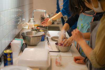 Midsection of woman having food at home