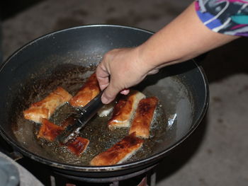 High angle view of person preparing food in cooking pan