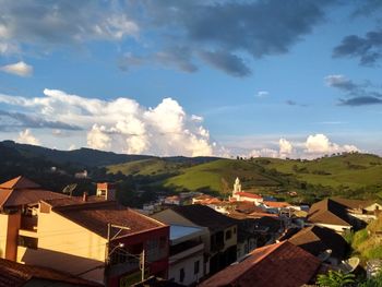 Houses in city against sky