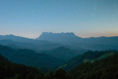 Scenic view of mountains against sky at night