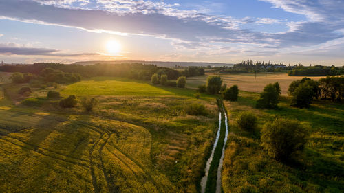 View of the landscape with traces of a tractor on a calm, summer early evening in the czech republic