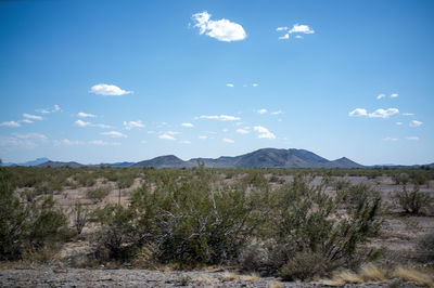 Scenic view of mountains against cloudy sky