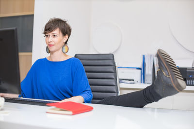 Young woman using laptop at home