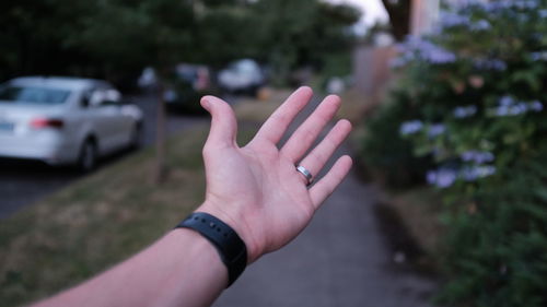 Close-up of hand on footpath 