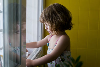 Woman looking through window