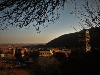 View of town against sky at sunset