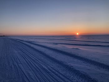 Scenic view of sea against clear sky during sunset