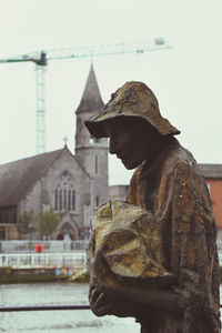 Statue of historic building against sky