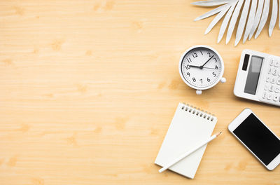 High angle view of clock on table