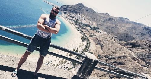 Full length of man standing on mountain against sky