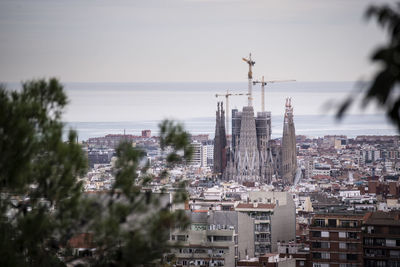 Buildings in city against sky in barcelona