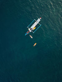 Aerial view of surfers and boat in the ocean, lombok, indonesia