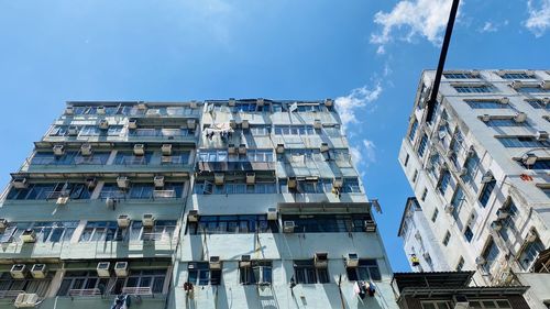 Low angle view of buildings against blue sky