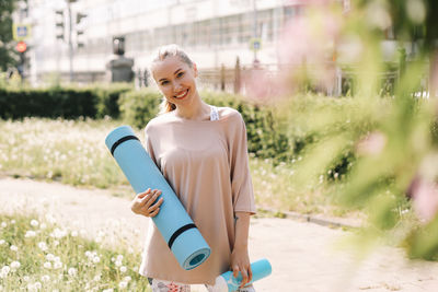 Happy fun healthy athletic girl in sportswear training and exercising in the park in nature outdoors