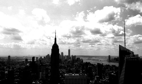 City skyline against cloudy sky