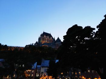 Low angle view of illuminated buildings against sky at dusk