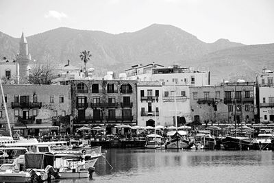 Boats in river with buildings in background