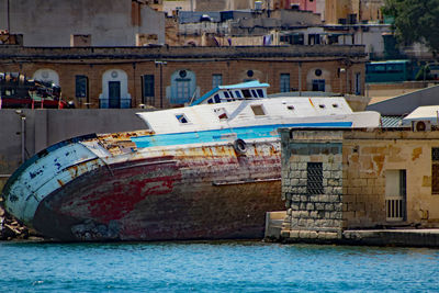 View of boats in sea against buildings