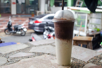 Close-up of coffee served on table in city