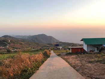 Road amidst landscape against sky during sunset