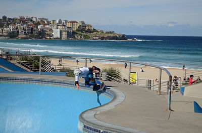 Man skateboarding on ramp at beach