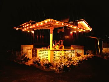 Illuminated building against sky at night