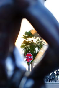 Close-up of road sign against sky