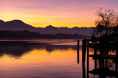 Scenic view of lake against romantic sky at sunset