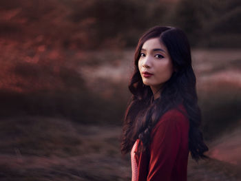 Portrait of young woman standing outdoors