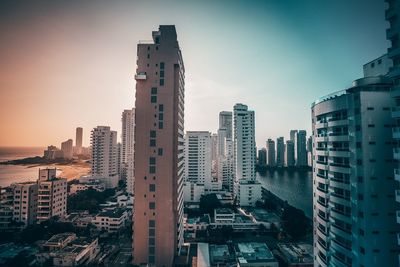 High angle view of buildings in city against sky during sunset