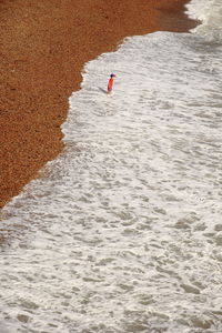 High angle view of boy standing at beach