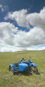 Car parked on golf course against sky