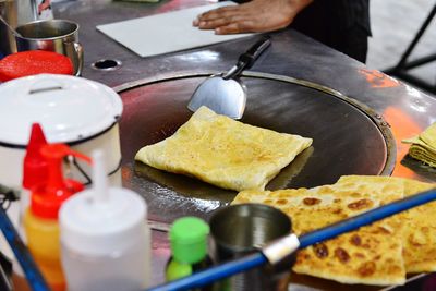 Cropped image of vendor preparing street food