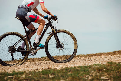 Athlete cyclist riding mountain bike uphill