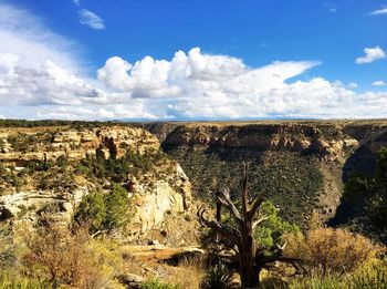 Scenic view of rocky landscape against cloudy sky